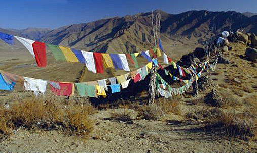 an image of Tibetan prayer flags in the mountains of the Himalayas